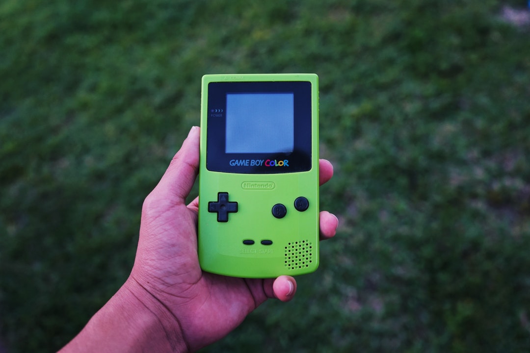 person holding game boy