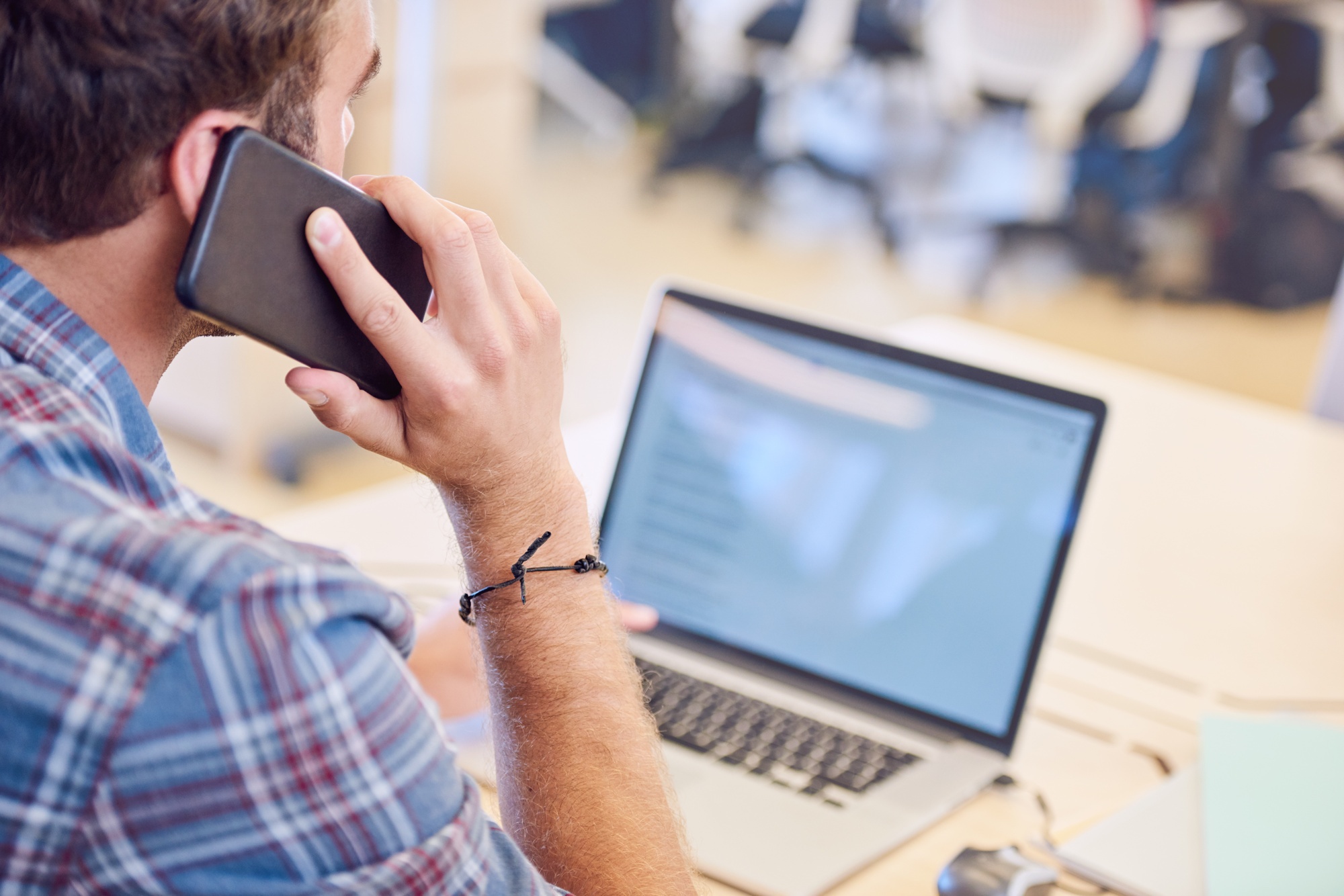 man on phone at computer