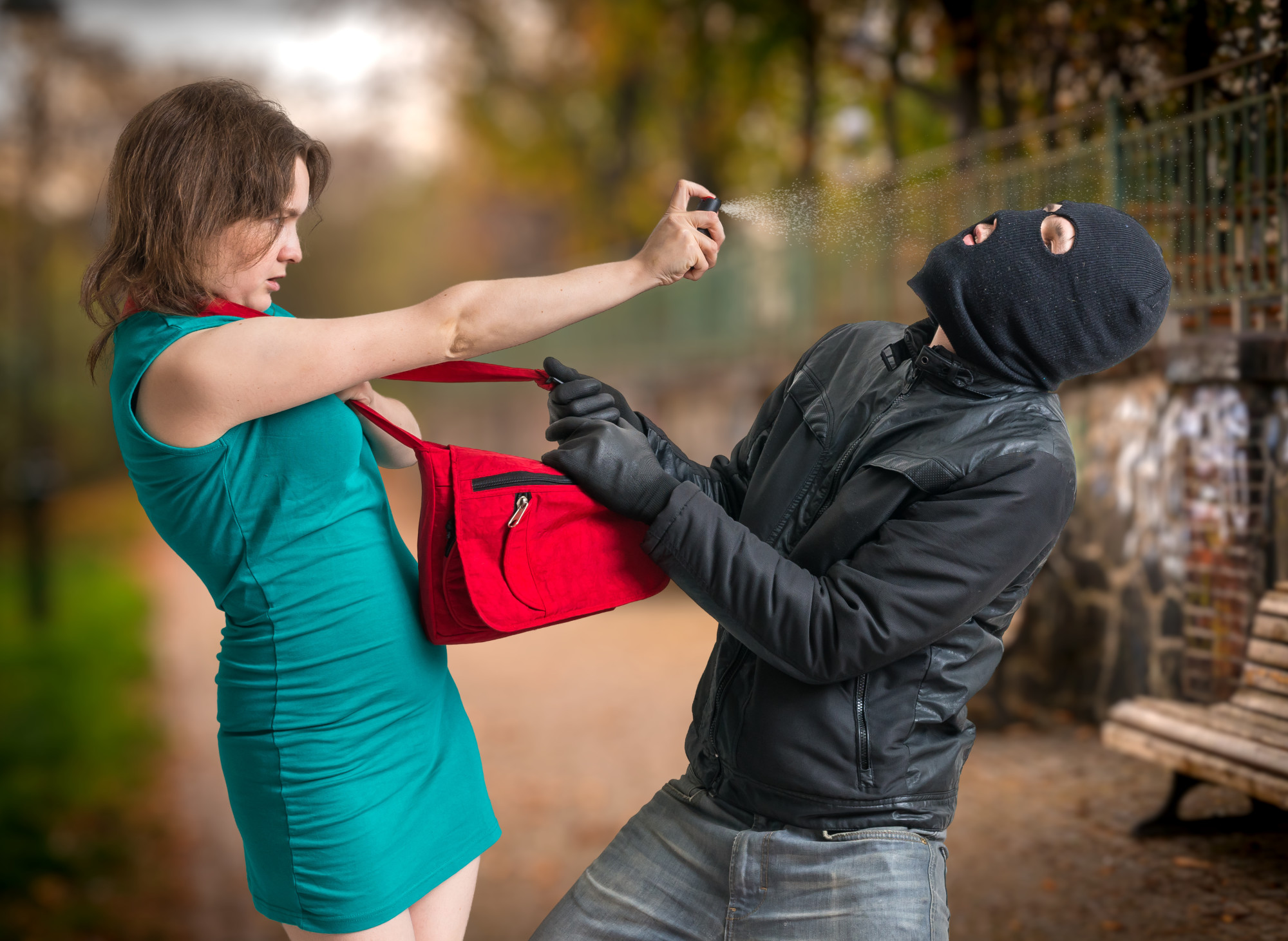 woman using pepper spray on attacker