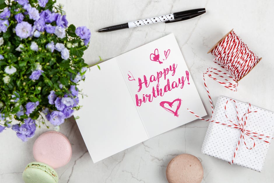 happy birthday written on card with gift